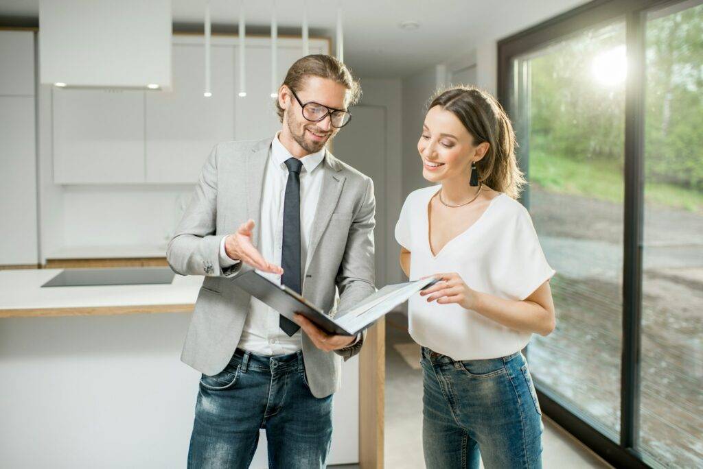 Woman with realtor in the modern apartment